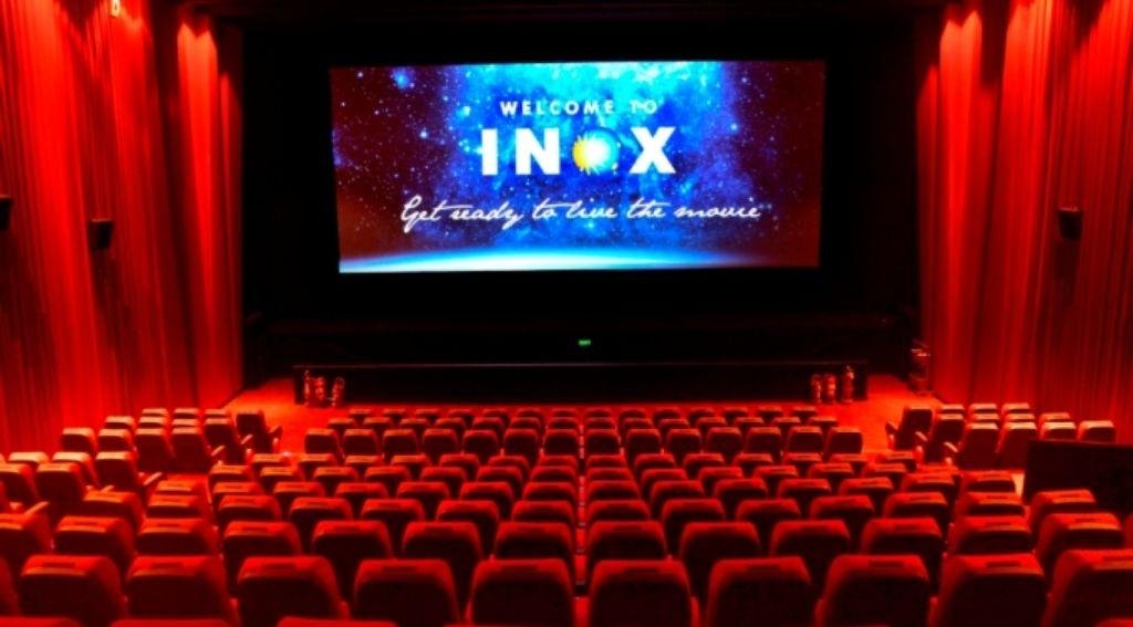 Family enjoying a movie together at a cinema in India