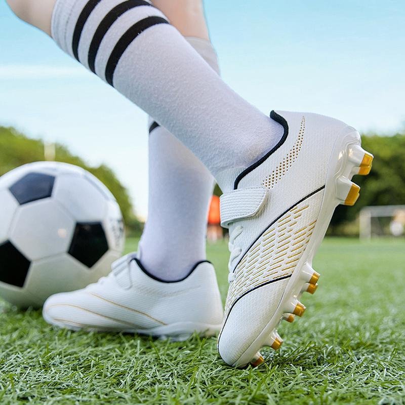 Football player wearing properly fitted soccer cleats on a grass pitch